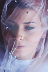 Close-up of young woman covered with veil