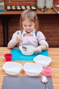 Girl making cake in classroom