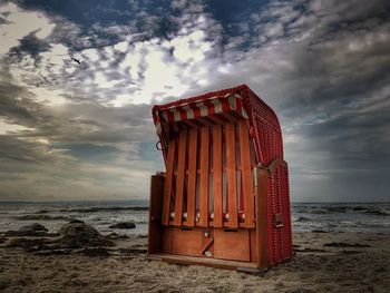 Lifeguard hut on beach against sky