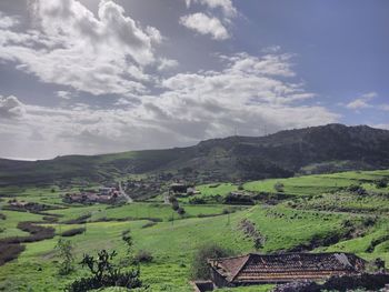 Scenic view of agricultural field against sky