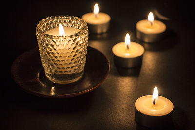 Close-up of lit candles on table