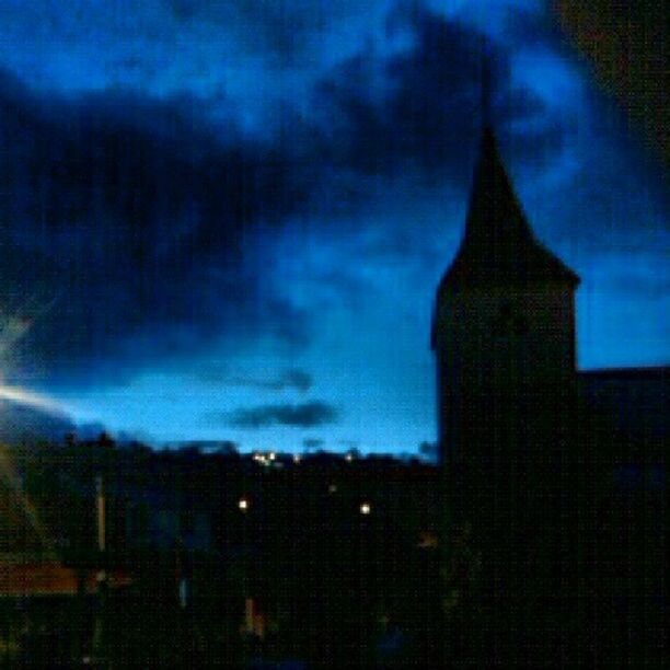 building exterior, architecture, built structure, sky, cloud - sky, dusk, tower, cloudy, city, cloud, silhouette, weather, church, night, low angle view, building, outdoors, no people, religion, blue