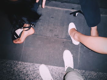 Low section of women standing on footpath