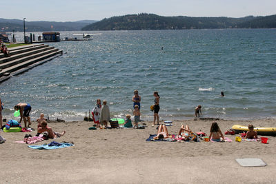 High angle view of people enjoying at beach during sunny day