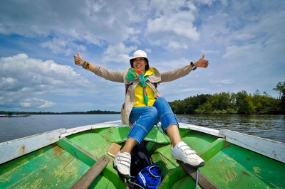 Full length of man on boat in lake against sky