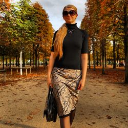 Young woman wearing sunglasses standing against trees