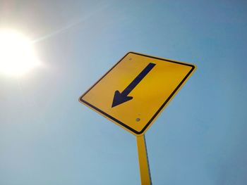 Low angle view of road sign against sky.