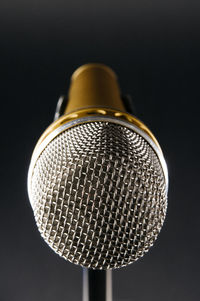 Close-up of guitar against black background