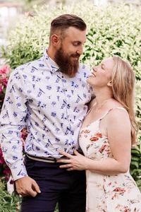 Young couple embracing while standing in park