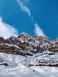 Snow covered mountain against blue sky