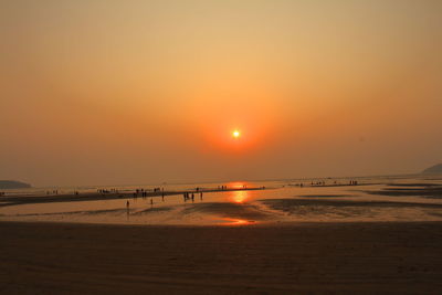 Scenic view of beach against sky during sunset