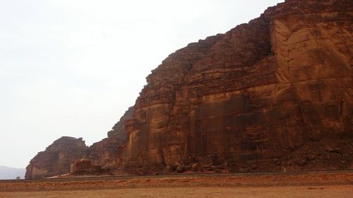 Low angle view of rock formations against sky