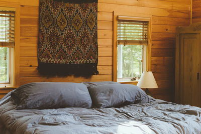 Cat on bed by window at home
