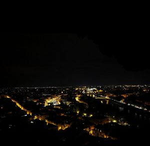 Aerial view of city lit up at night