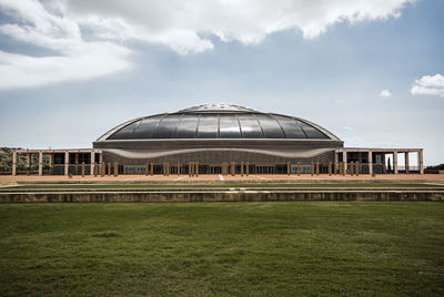 Built structure on field against sky