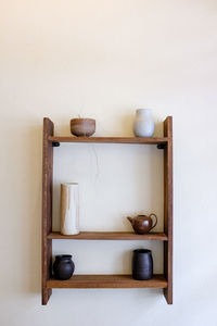 Close-up of kitchen utensils on table against wall at home