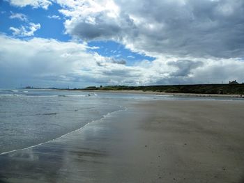 Scenic view of sea against cloudy sky