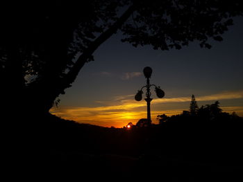 Low angle view of silhouette trees against sky at sunset