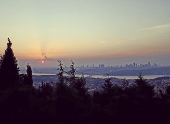 Silhouette of city at sunset