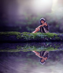 Woman with umbrella on lake