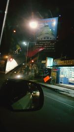 View of illuminated road at night