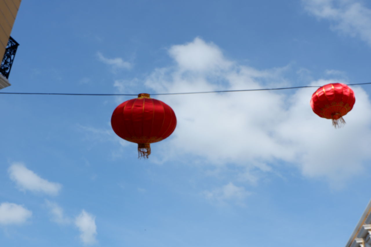 LOW ANGLE VIEW OF RED LANTERN HANGING AGAINST SKY
