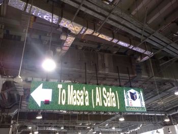 Low angle view of illuminated text on building at night