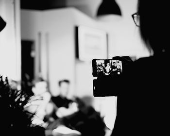 Woman photographing through mobile phone