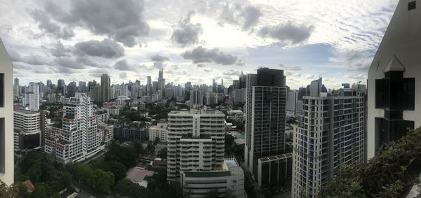 Panoramic view of modern buildings in city against sky