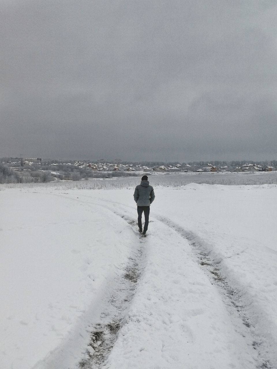 winter, cold temperature, nature, rear view, full length, snow, one person, weather, beauty in nature, sea, tranquility, outdoors, walking, sky, standing, tranquil scene, scenics, day, water, real people, beach, horizon over water, salt - mineral, people