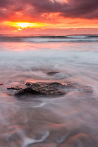 Scenic view of sea against dramatic sky