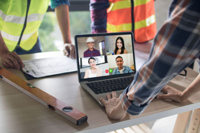 Group of people using laptop on table