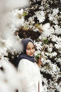 Portrait of woman with white flowers