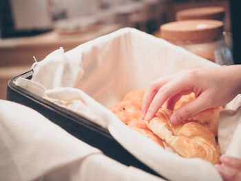 Close-up of person holding ice cream on table