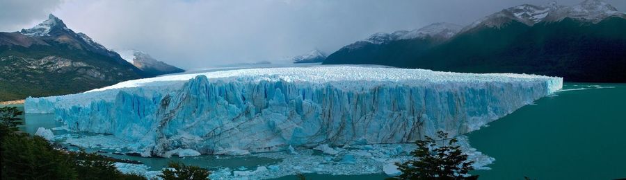 Panoramic view of frozen lake against mountain range