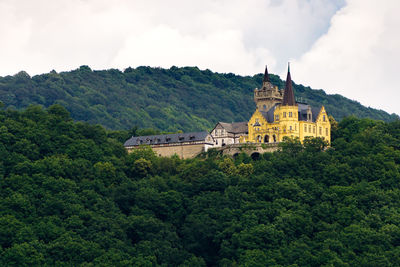 View of castle on mountain against cloudy sky