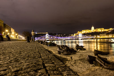 View of suspension bridge over river at night