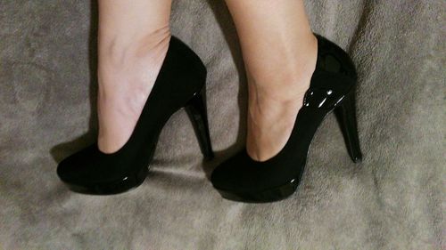 Low section of woman in high heels