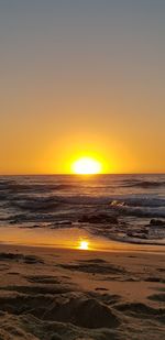 Scenic view of sea against romantic sky at sunset