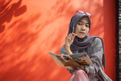 Portrait of young woman using mobile phone