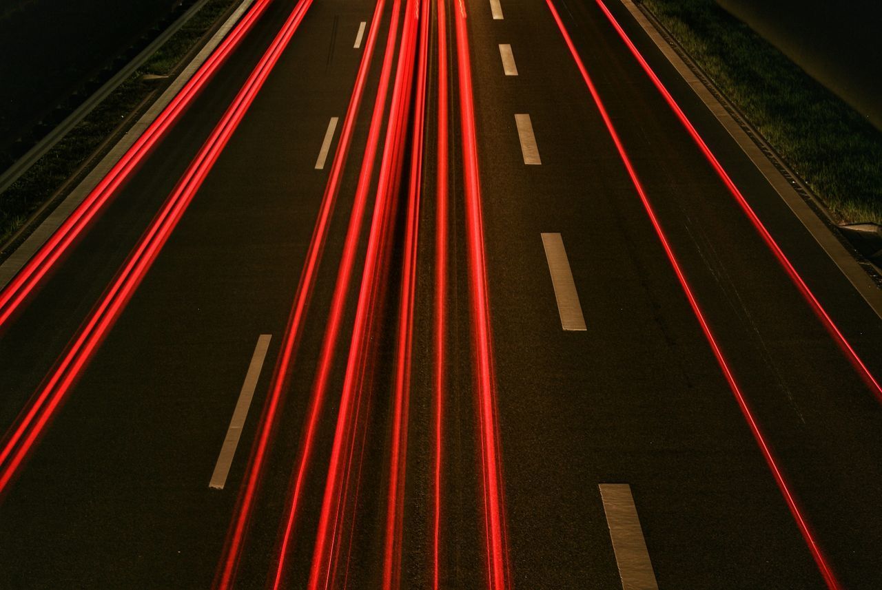 LIGHT TRAILS ON ROAD AT NIGHT