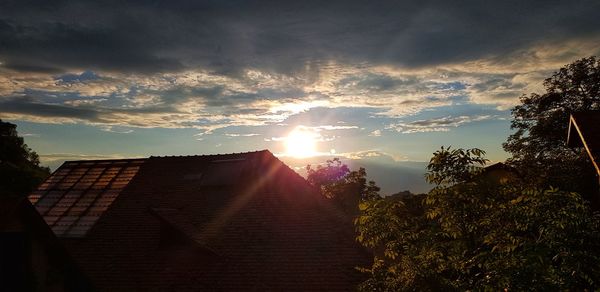 Scenic view of building against sky during sunset