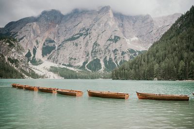 Scenic view of lake by mountains during winter