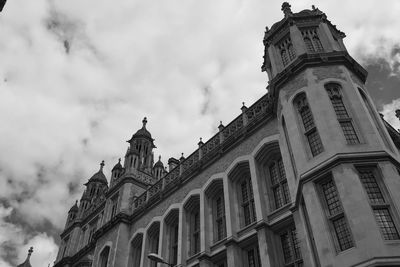 Low angle view of church against cloudy sky