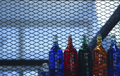 Multi colour row of bottles on the shelf