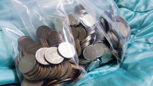 High angle view of coins on bed