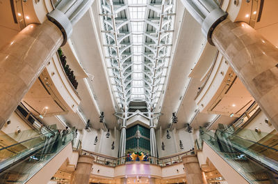 Low angle view of illuminated chandelier hanging in shopping mall