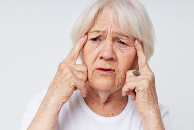 Senior woman against white background