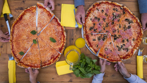 High angle view of woman holding pizza