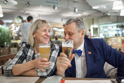 Mature couple enjoying beer in restaurant